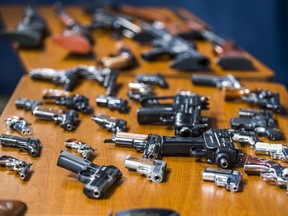 Toronto Police display some of the guns acquired following a gun buyback program, during a press conference at police headquarters in Toronto, in 2019.