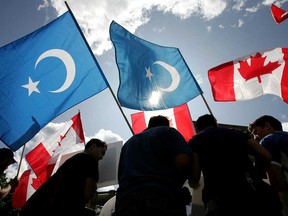 Protesters from the Uyghur-Canadian community wave East Turkestan and Canadian flags outside the Alberta Legislature as they call on the Canadian government to stop the oppression and slaughter of their people in the Xingijang province of China, once known as East Turkestan, in a file photo from 2015.
