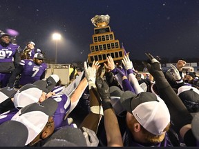 Western University Mustangs players carry the trophy after winning over the Saskatchewan Huskies, at the Vanier Cup in Quebec City Saturday, Dec. 4, 2021. THE CANADIAN PRESS/Bernard Brault