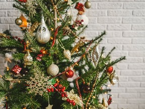 Beautiful decorated Christmas tree on white wall background.