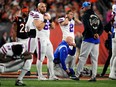 Buffalo Bills head coach Sean McDermott takes a knee is as Buffalo Bills safety Damar Hamlin (3) is tended to on the field following a collision in the first quarter against the Cincinnati Bengals at Paycor Stadium.