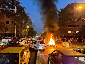 A police motorcycle burns during a protest over the death of Mahsa Amini, a woman who died after being arrested by the Islamic republic's "morality police", in Tehran, Iran September 19, 2022. Faezeh Hashemi, a former lawmaker and the daughter of ex-President Ali Akbar Hashemi Rafsanjani, had been arrested for “inciting rioters” in September, days after the death in police custody of 22-year-old Mahsa Amini sparked nationwide unrest.
