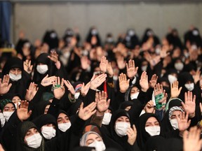 This handout picture provided by the office of Iran's Supreme Leader Ayatollah Ali Khamenei shows women waving as they attend his address in the capital Tehran on January 9, 2023.