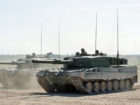 Two Canadian Forces Leopard 2A4 tanks on the firing range at CFB Gagetown, N.B., in 2012.