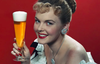 happy woman holding a beer