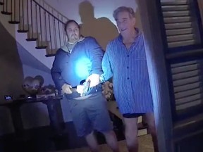In the body cam footage, two police officers knock on the door at the Pelosis' home. When the door opens, Pelosi and DePape can both be seen clutching a large hammer.