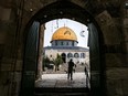 People walk towards the Dome of the Rock shrine at the Aqsa mosque compound, also known as the Temple Mount complex to Jews, in the old city of Jerusalem on January 3, 2023. (AHMAD GHARABLI / AFP)