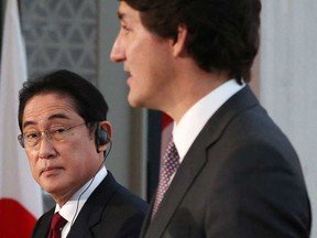 Japanese Prime Minister Fumio Kishida listens to Prime Minister Justin Trudeau during a news conference in Ottawa on Jan. 12, 2023.