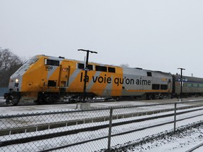 A VIA Rail passenger train sits idle at the station in Cobourg, Ont., after it was cancelled due to service stoppages, December 24, 2022.
