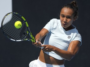 Leylah Fernandez of Canada plays a backhand return to Alize Cornet of France during their first round match at the Australian Open tennis championship in Melbourne, Australia, Tuesday, Jan. 17, 2023.