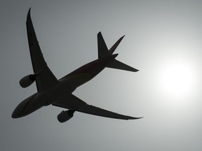 A plane is silhouetted as it takes off from Vancouver International Airport in Richmond, B.C., Monday, May 13, 2019. New Democrat Leader Jagmeet Singh says he wants to see more competition within Canada's airspace in order to make flying more affordable for people.THE CANADIAN PRESS/Jonathan Hayward