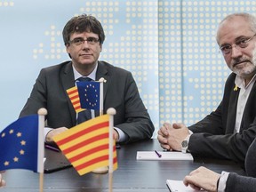 FILE - Catalan leader Carles Puigdemont, left, and former Catalan Minister of Culture Lluis Puig Gordi, in Brussels on Jan. 24, 2018. The European Union's top court has issued a ruling that allows Spain to make another attempt to seek the extradition of a former Catalan separatist politician living in Brussels. Spain has unsuccessfully tried to get Belgium to hand over Lluís Puig since he fled Spain following an illegal 2017 secession bid for Catalonia. The Court of Justice of the EU, based in Luxembourg, now says that a EU country can only refuse to execute a European arrest warrant if a judge determines that the other member's judiciary suffers "systemic or generalized deficiencies."