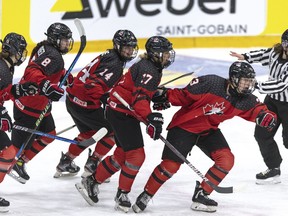 Canada's Caitlin Kraemer, foreground right, celebrates scoring with teammates from left, Ava Murphy, Piper Grober, Emma Pais and Alex Law after scoring the opening goal during the women's under-18 ice hockey world championship match between Canada and Sweden at the Ostersund Arena, in Ostersund, Sweden, on Sunday, Jan. 15, 2023.