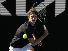 Alexander Zverev of Germany plays a backhand return to Michael Mmoh of the U.S. during their second round match at the Australian Open tennis championship in Melbourne, Australia, Thursday, Jan. 19, 2023.