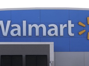 FILE - A Walmart logo is displayed outside of a Walmart store, in Walpole, Mass, Sept. 3, 2019.