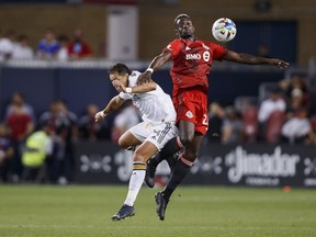 Toronto FC defender Chris Mavinga (23) and Los Angeles Galaxy forward Javier Hernández (14) jump for a ball during first half MLS soccer action in Toronto on Wednesday, Aug. 31, 2022.&ampnbsp;Mavinga, who spent the last six seasons with Toronto FC, has signed with the Los Angeles Galaxy. THE&ampnbsp;CANADIAN PRESS/Cole Burston