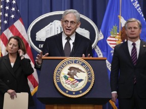 Attorney General Merrick Garland speaks during a news conference at the Department of Justice in Washington, Friday, Jan. 27, 2023, to discuss recent law enforcement action in transnational security threats case. Deputy Attorney General Lisa Monaco, left, and FBI Director Christopher Wray, listen.