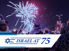 Israeli youths watch fireworks over the centre of Jerusalem late on April 18, 2018, during the conclusion of Memorial Day and the start of the 70th Independence Day celebrations.