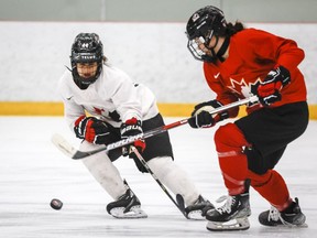 Jade Iginla, left, and Jordan Baxter chase the puck during a Canada's national women's under-18 team inter-squad game in Calgary, Alta., Friday, May 27, 2022. The women's world under-18 hockey championship returns to its regular time slot with Canada chasing a second gold medal in less than seven months. THE ;CANADIAN PRESS/Jeff McIntosh
