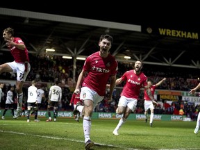 Wrexham's Tom O'Connor celebrates scoring against Sheffield United during the English FA Cup fourth round soccer match at The Racecourse Ground, Wrexham, Wales, Sunday Jan. 29, 2023.