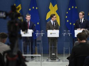 From left, Sweden's Defense Minister Pal Jonson, Prime Minister Ulf Kristersson and Foreign Minister Tobias Billstrom attend a news conference on Sweden's NATO bid in Stockholm, Sweden, Tuesday Jan. 24, 2023. On Monday, Turkish President Recep Tayyip Erdogan warned Sweden again not to expect support for its application following weekend protests in Stockholm by an anti-Islam activist and pro-Kurdish groups.