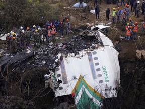 FILE- Rescuers scour the crash site of a passenger plane in Pokhara, Nepal, Monday, Jan. 16, 2023. The black box recovered from last week's plane crash in Nepal is being sent to Singapore for analysis to identify the cause of the crash that killed all 72 people on board, officials said Thursday, Jan 26.