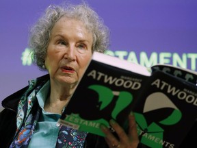 FILE - Canadian author Margaret Atwood holds a copy of her book "The Testaments," during a news conference on Sept. 10, 2019, in London. A years-long saga that ensnared the publishing world culminated in a New York courtroom Friday, Jan. 6, 2023, when a con artist pleaded guilty to a plot that defrauded scores of authors, including Atwood, by duping them into handing over hundreds of unpublished manuscripts.