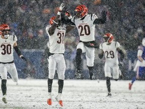 Cincinnati Bengals safety Michael Thomas (31) and Cincinnati Bengals cornerback Eli Apple (20) react after a defensive play against the Buffalo Bills during the fourth quarter of an NFL division round football game, Sunday, Jan. 22, 2023, in Orchard Park, N.Y.
