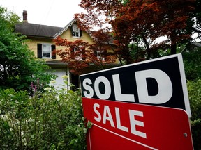 FILE - A sale sign stands outside a home in Wyndmoor, Pa., Wednesday, June 22, 2022. On Friday, the National Association of Realtors reports on sales of existing homes in December.