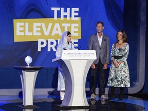 In this photo provided by Elevate Prize Foundation, Nobel Peace Prize winner Malala Yousafzai receives the Elevate Prize Catalyst Award from the Elevate Prize Foundation's Joseph Deitch and Carolina García Jayaram in New York in Sept. 2022. All three were judges for the 2023 Elevate Prize.