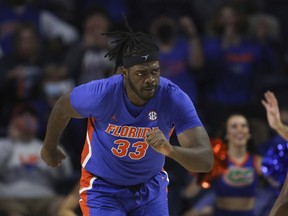 Florida center Jason Jitoboh (33) runs up court after making a shot against Alabama during the first half of an NCAA college basketball game, Jan. 5, 2022, in Gainesville, Fla. Jitoboh took a finger to his left eye at Tennessee last January and spent the better part of a year trying to get right. He's had four surgeries already and might have a fifth following the season. He faces the second-ranked Volunteers for the first time since his injury when Florida hosts Tennessee on Wednesday.