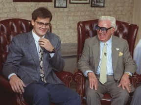 FILE - Hall of Fame baseball announcer Harry Caray, right, laughs with his grandson Chip in Chicago in this May 13, 1991 photo. Longtime broadcaster Chip Caray is taking over as the play-by-play voice of the St. Louis Cardinals, more than five decades after his grandfather and Hall of Fame broadcaster Harry Caray became a baseball staple with the same club. Bally Sports Midwest announced Caray's hiring in a statement Monday, Jan. 30, 2023.