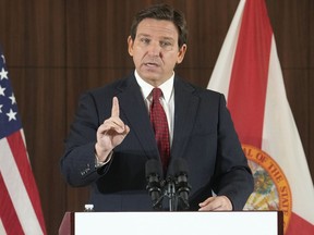 FILE - Florida Gov. Ron DeSantis gestures during a news conference, Thursday, Jan. 26, 2023, in Miami. DeSantis on Tuesday, Jan. 31, 2023, announced plans to block state colleges from having programs on diversity, equity and inclusion, and critical race theory.