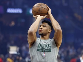 Milwaukee Bucks forward Giannis Antetokounmpo shoots before an NBA basketball game between the Cleveland Cavaliers and the Milwaukee Bucks, Saturday, Jan. 21, 2023, in Cleveland. Antetokounmpo will not play against Cleveland.