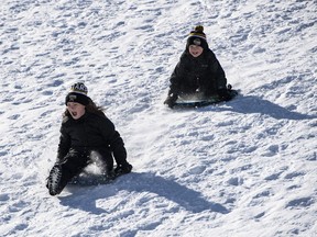 Kids go tobogganing at Lansdowne Park in Ottawa on Family Day, Monday, Feb. 17, 2020. A proposal to ban tobogganing at all but two municipal parks in a city east of Toronto is drawing criticism from lawyers who say the plan won't boost safety but could limit access to the popular winter pastime.