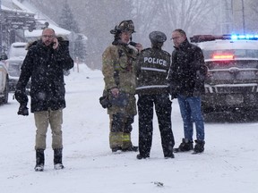 Police and fire officials block a road near the scene after an explosion at a propane facility in St-Roch-de-l'Achigan, Que., north of Montreal on Thursday, Jan.12, 2023.