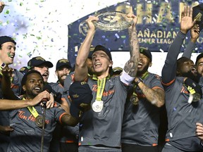 Forge FC's Daniel Krutzen (5) raises the trophy after his team's win over Atletico Ottawa in the Canadian Premier League final in Ottawa on Sunday, Oct. 30, 2022.