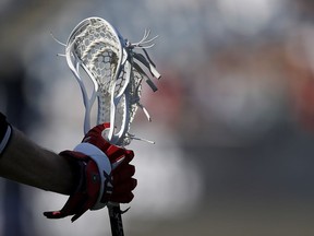 A lacrosse stick is held during a game in Foxborough, Mass. on Saturday, June 5, 2021. Major Series Lacrosse says it hopes that Brampton and Owen Sound will both play in the Ontario-based league in 2023. The two clubs came to an agreement on Thursday over the issue of a player pool.THE CANADIAN PRESS/AP/Steve Luciano