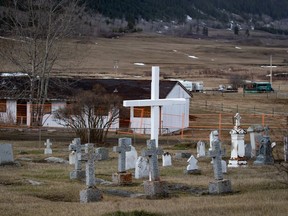 A cemetery and a boarded-up abandoned building are seen on the former grounds of St. Joseph's Mission residential School, in Williams Lake, B.C., on March 30, 2022.