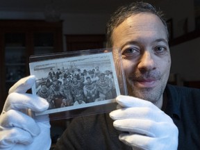 Historian David Saint-Pierre shows photos of the salvage operation from the sinking of the Empress of Ireland in 1914 at his home, Thursday, January 12, 2023 in Montreal.THE CANADIAN PRESS/Ryan Remiorz