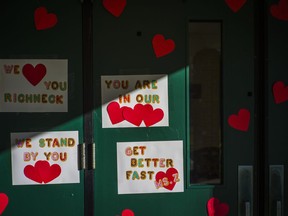 Messages of support for teacher Abby Zwerner, who was shot by a student, cover the front door of Richneck Elementary School Newport News, Va., on Jan. 9, 2023. The teacher's lawyer says she is suing the school board.