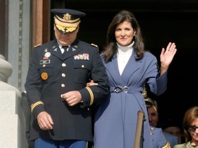 Former South Carolina Gov. Nikki Haley, right, waves as she and her husband, Michael Haley, left, are introduced at the second inaugural of Gov. Henry McMaster on Wednesday, Jan. 11, 2023, in Columbia, S.C.