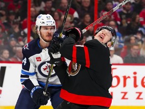 Ottawa Senators left wing Brady Tkachuk (7) reacts to a stick check from Winnipeg Jets defenceman Dylan Samberg (54) during second period NHL hockey action in Ottawa on Saturday, Jan. 21, 2023.