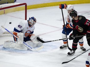 Ottawa Senators centre Shane Pinto scores on New York Islanders goaltender Semyon Varlamov as Islanders defenceman Sebastian Aho defends during first period NHL action, Wednesday, January 25, 2023 in Ottawa.