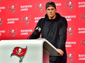 Tom Brady #12 of the Tampa Bay Buccaneers speaks to the media after losing to the Dallas Cowboys 31-14 in the NFC Wild Card playoff game at Raymond James Stadium on January 16, 2023 in Tampa, Florida.