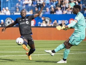 CF Montréal forward Kei Kamara (23) moves in on New York City goalkeeper Sean Johnson (1) during first half Eastern Conference semifinals MLS playoff soccer action in Montreal, Sunday, October 23, 2022. Kamara says his affection for Montreal has not changed, even as the striker's contract dispute with the city's Major League Soccer club dominates training camp.THE CANADIAN PRESS/Graham Hughes