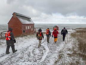 Members of a ground search and rescue team walk along the shore of the Bay of Fundy in Hillsburn, N.S. as they look for five fishermen missing after the scallop dragger Chief William Saulis sank in the Bay of Fundy, on Wednesday, Dec. 16, 2020. As Canadian fishers continue to die in frigid waters when their boats capsize, a debate is surfacing over why clear rules aren't in place to ensure basic stability of vessels that face ocean storms.THE CANADIAN PRESS/Andrew Vaughan