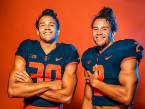 Sydney Brown (30), Chase Brown (2), identical twin brothers from London, Ont., pose in this undated handout photo. The twins are making the winter edition of the CFL scouting bureau a family affair. Chase Brown, a running back at Illinois, remains atop the list after doing so in the fall edition that was released in September. Sydney Brown, a defensive back with the Fighting Illini, moves into second position after holding down third in September.THE CANADIAN PRESS/HO - Illinois Athletics, Michael Glasgow