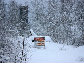 A sign and headframe appear at the abandoned Ptarmigan Mine outside of Yellowknife, Thursday, Jan. 19, 2023. It's one of six abandoned mines in the N.W.T. where it has yet to be determined whether the federal or territorial government is responsible for the cleanup.