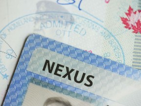 A NEXUS card and a Canadian passport are pictured in Ottawa on Tuesday, Jan. 17, 2023. A New York congressman wants to add some Zoom to the sluggish effort to clear a bilateral backlog of Nexus trusted-traveller applications.